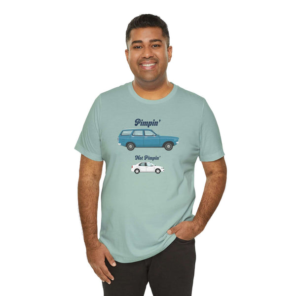 Man wearing a light blue 'Pimpin Not Pimpin' tee featuring Subaru GL 1600 graphic design.