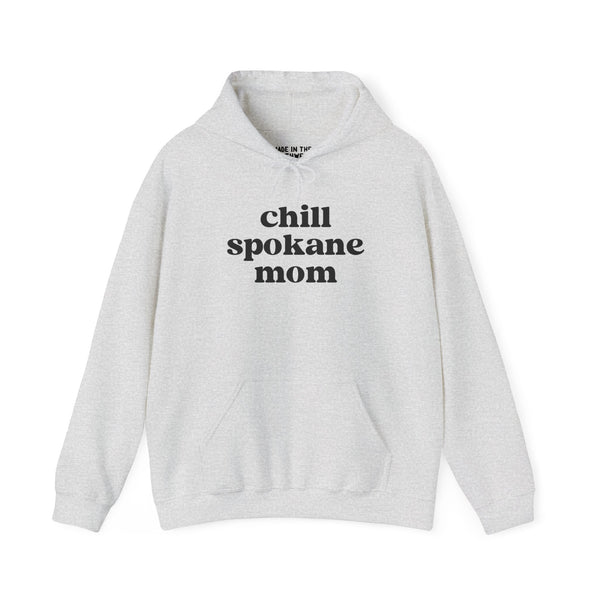 Cozy gray hoodie featuring the text 'chill spokane mom', perfect for laid-back moms who love the outdoors.