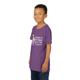 Child wearing a purple 'People in Portland Don't Tan, They Rust' tee, perfect for rainy PNW fun.
