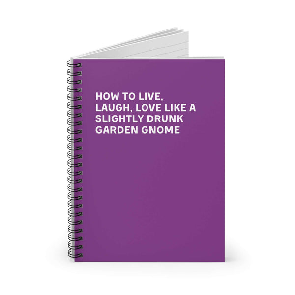 Purple spiral notebook with humorous text on living, laughing, and loving like a slightly drunk garden gnome.