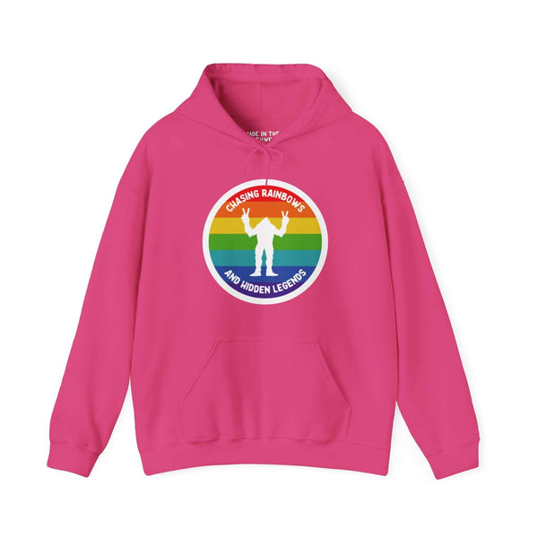 Pink hoodie with rainbow Sasquatch graphic, "Chasing Rainbows and Hidden Legends," celebrating PNW spirit and local pride.