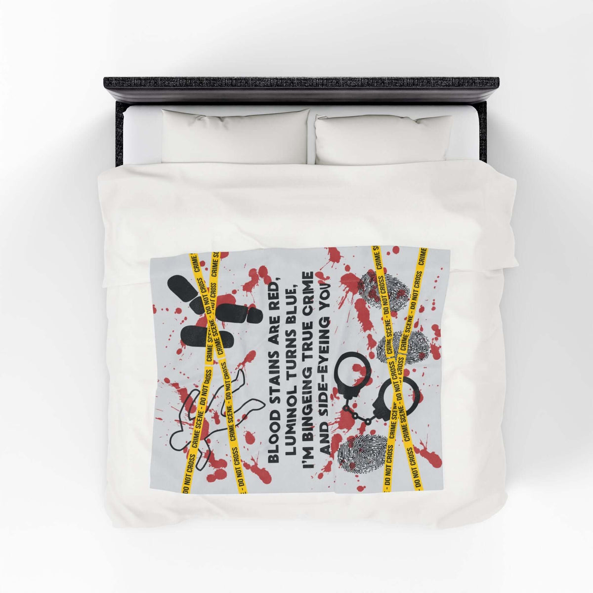 The Crime Scene Snuggle Lightweight Blanket for True Crime Lovers displayed on a bed with bold crime scene designs.