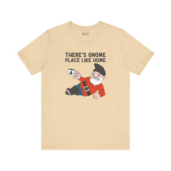 Beige tee featuring a reclining gnome with the phrase 'There's Gnome Place Like Home,' ideal for cozy, whimsical fashion lovers.