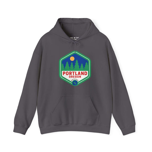 Retro Portland hoodie with 90s-inspired badge of trees and city name, representing urban and natural beauty of the Pacific Northwest.