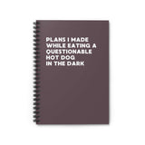 Spiral notebook titled 'Plans I Made While Eating a Questionable Hot Dog in the Dark' with a dark cover.