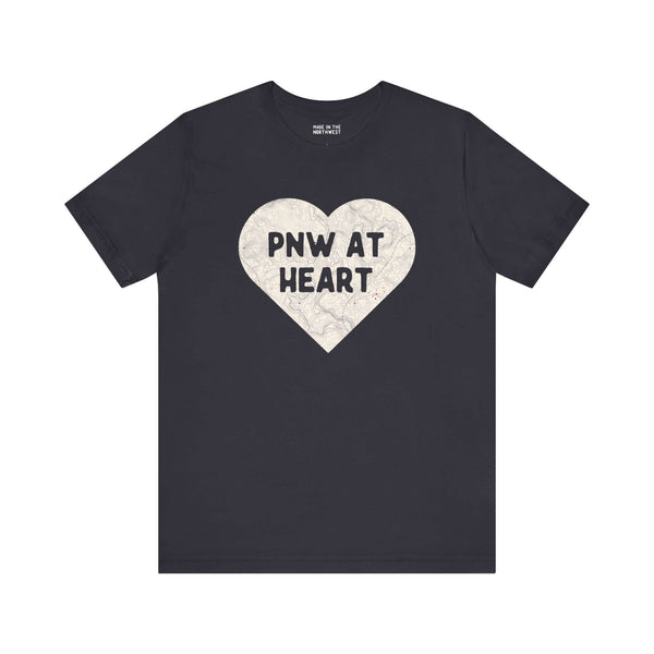 Black tee with heart-shaped map print featuring "PNW at Heart", showcasing Pacific Northwest pride.