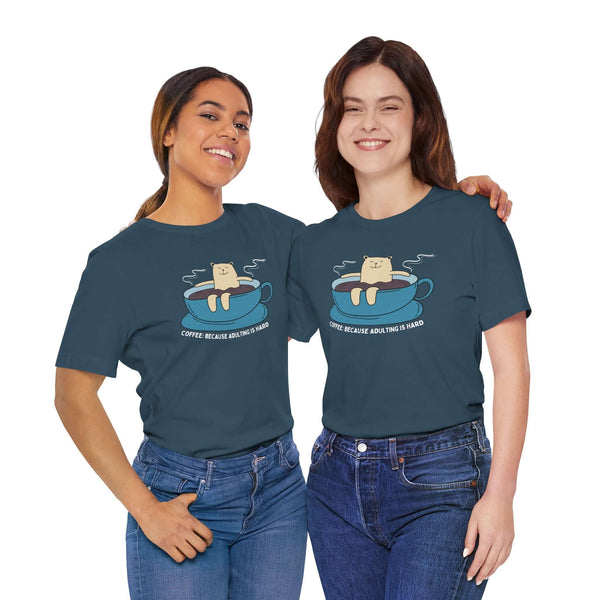 Two women wearing Coffee Because Adulting is Hard tee, showcasing a fun coffee-themed design.
