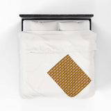 Tiny Trailer Travels RV Lightweight Cozy Blanket spread on a white bed, showcasing a charming travel trailer pattern.