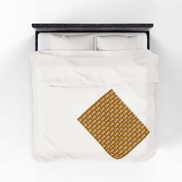 Tiny Trailer Travels RV Lightweight Cozy Blanket spread on a white bed, showcasing a charming travel trailer pattern.