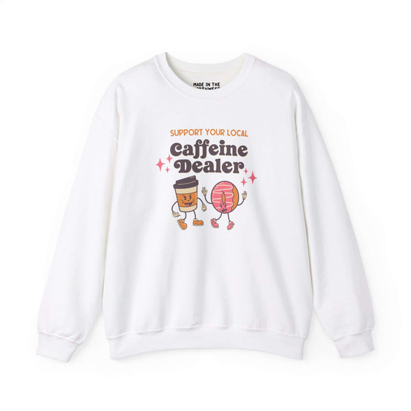 White sweatshirt featuring playful design 'Support Your Local Caffeine Dealer' with coffee cup and donut graphics.