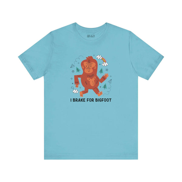 I Brake for Bigfoot Soft Tee Show your playful side and love for local folklore with our "I Brake for Bigfoot" Sasquatch Tee. This fun design features the phrase "I Brake for Bigfoot" alongside a whimsical graphic of a Sasquatch, perfect for those who enj