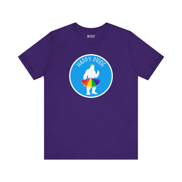 Purple tee featuring a Bigfoot silhouette in a rainbow tutu with text 'Happy Pride', celebrating Pride spirit.