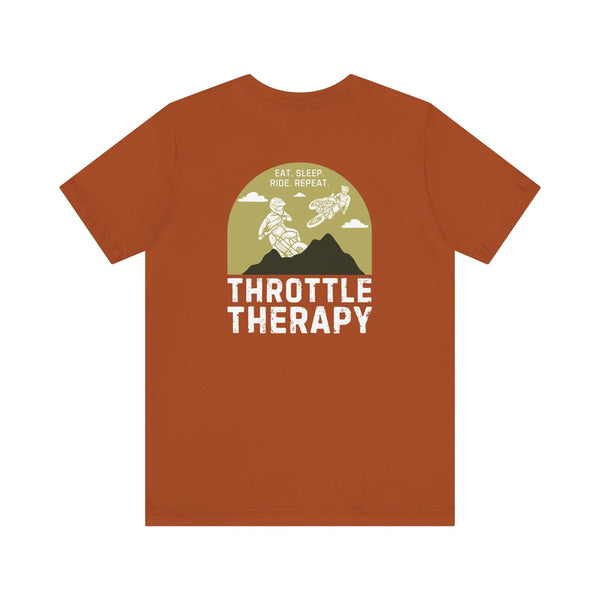 Throttle Therapy soft tee with dirt bikers jumping against mountain backdrop, perfect for motocross enthusiasts, in brown color.