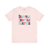 Bold and bright Seattle trio premium soft tee featuring colorful block lettering design.