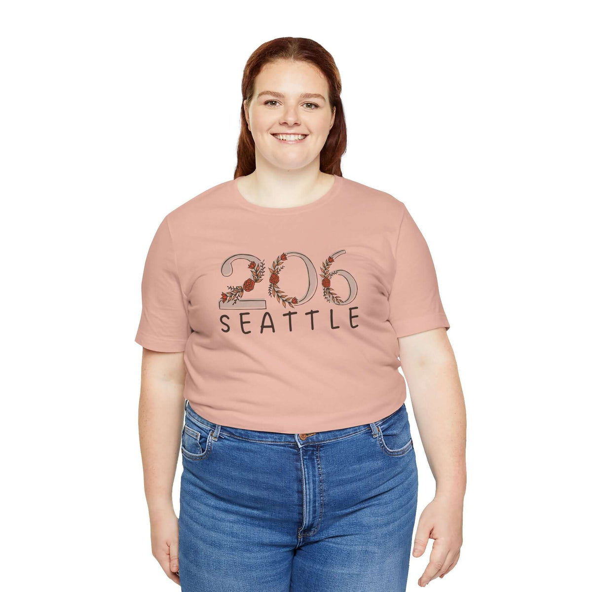 Woman wearing a 206 Floral Area Code Premium Soft Tee in pink, showcasing Seattle pride with nature-inspired design.