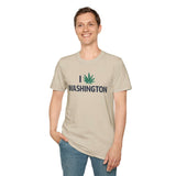 A man wearing a beige I Marijuana Washington T Shirt with a leaf graphic, smiling in a casual setting.