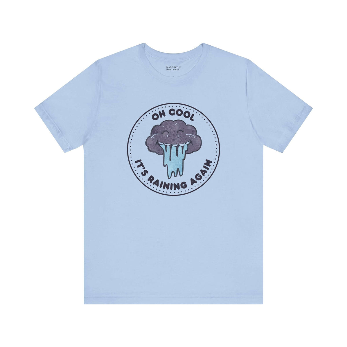 Oh Cool It's Raining Again T Shirt, featuring a playful storm cloud design on a light blue background.