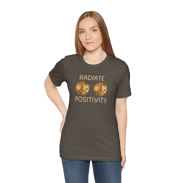 Woman wearing Radiate Positivity Premium Soft Tee with floral glasses design in olive green.
