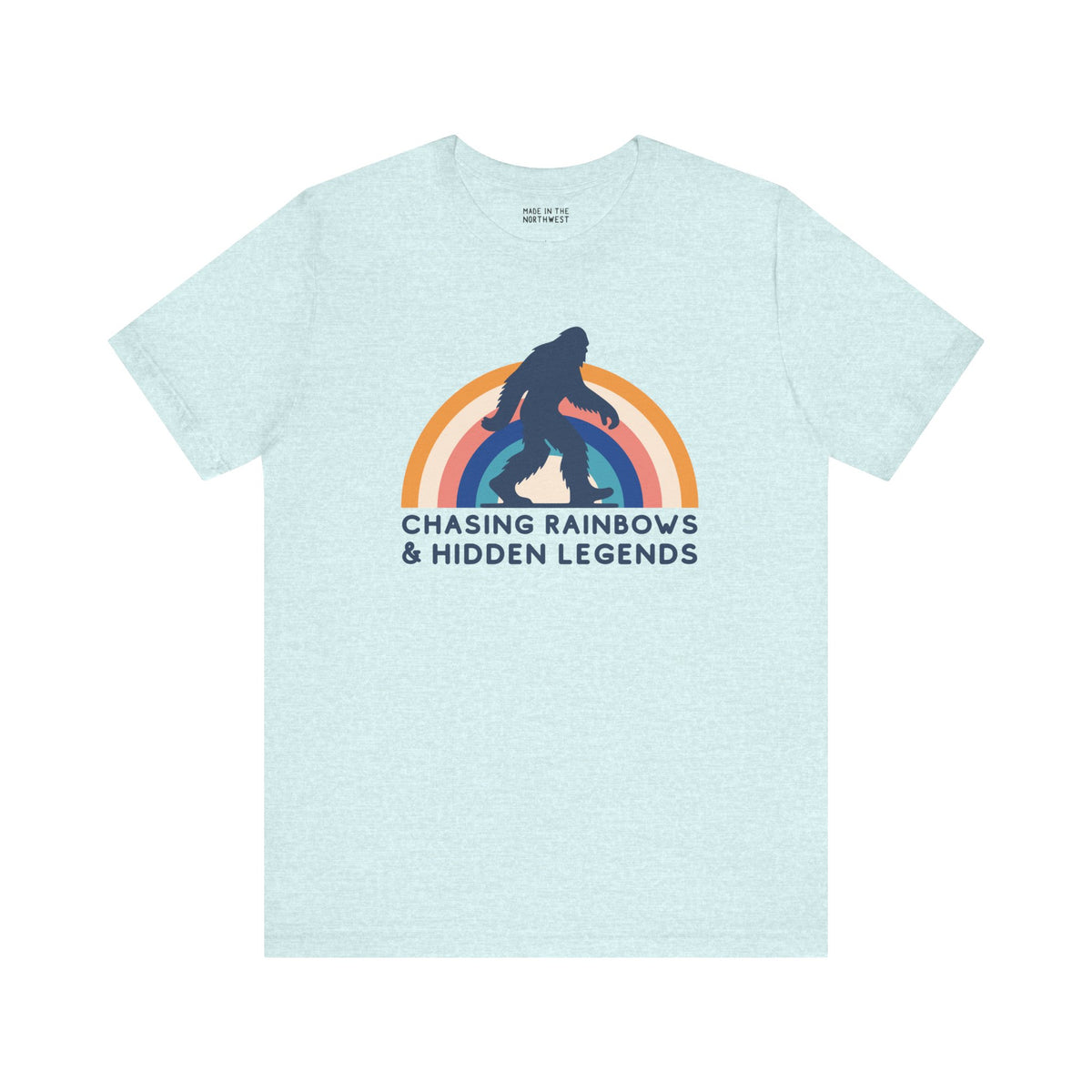 Chasing Rainbows and Hidden Legends tee featuring a vibrant Sasquatch graphic and rainbow design, perfect for PNW pride.
