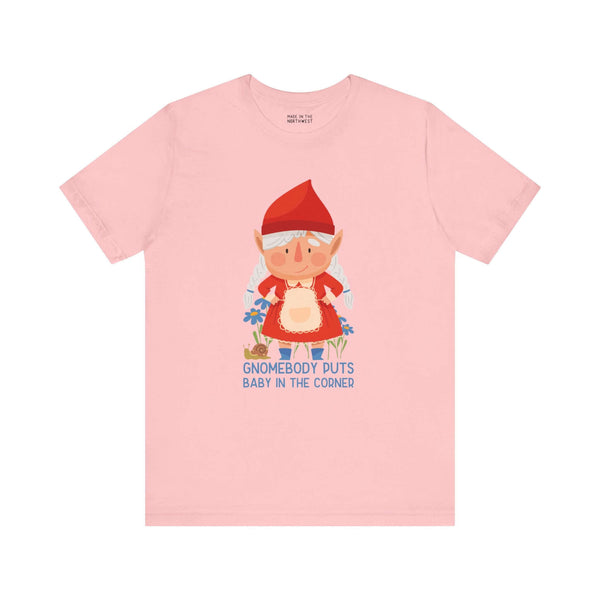 Pink t-shirt featuring a female gnome with text "Gnomebody Puts Baby in the Corner" adding a whimsical and playful touch.