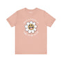 What a F*cked Up Time to Be Alive premium soft tee with smiling daisy design on peach background.