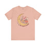 Take a Moment to Breathe T Shirt with crescent moon and wildflowers design on a soft pink tee.