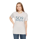 Woman wearing a white 509 Floral Area Code Premium Soft Tee showcasing Spokane pride in PNW style.