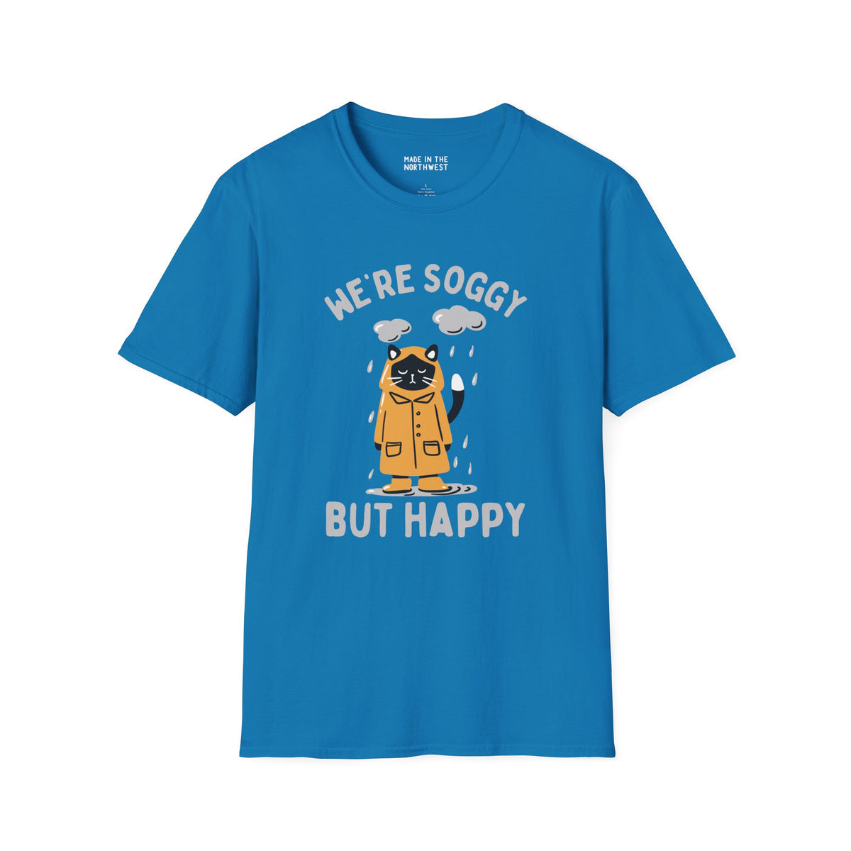 Blue t-shirt featuring a drenched cat in a raincoat with the text 'We're Soggy But Happy', perfect for Pacific Northwest lovers.