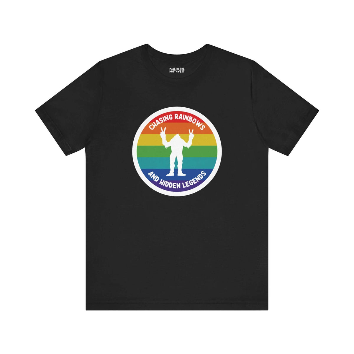 Chasing Rainbows Sasquatch Soft Tee Celebrate your roots with a splash of color and a touch of mystery in our "Hometown Pride" tee. Featuring a vibrant rainbow circle and a playful Sasquatch graphic, this shirt embodies the unique and spirited vibe of the