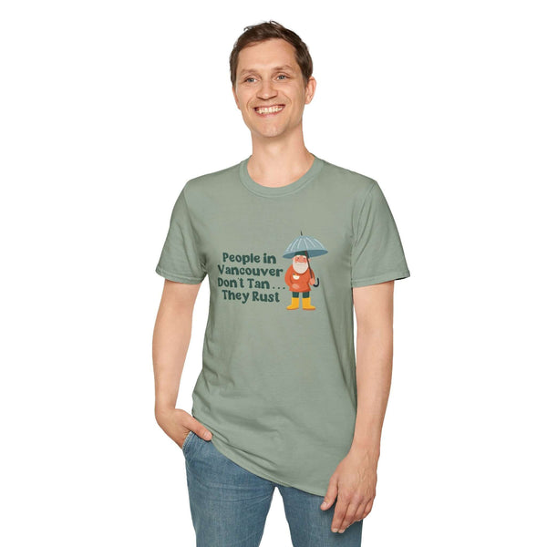 Man wearing a softstyle t-shirt featuring a gnome with an umbrella and the text 'People in Vancouver Don't Tan, They Rust'.