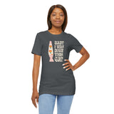 Model wearing Baby I Was Born This Gay Premium Soft Tee in dark gray with colorful, bold lettering.