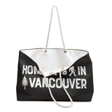Home is in Vancouver Weekender Bag showcasing sasquatch design and rope handles, perfect for adventures and beach trips.