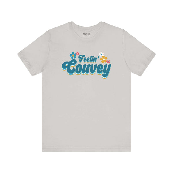 Feelin' Couvey Retro Soft Tee Embrace the vibrant spirit of Vancouver, Washington with our "Feelin' Couvey" Retro Tee! This playful design features the phrase "Feelin' Couvey" in a nostalgic 70s font, complete with colorful aqua and pink flowers. A fun tw