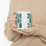 Person holding a Three-Six-Oh Pop ceramic mug featuring vibrant 360 design, embodying PNW pride.