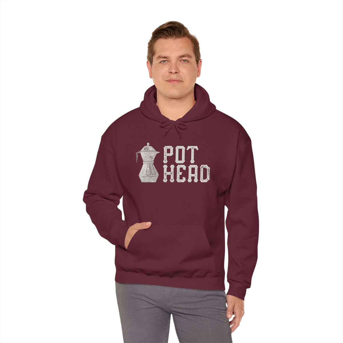 Man wearing a maroon hoodie with Moka pot graphic and "Pot Head" text, celebrating traditional espresso brewing.