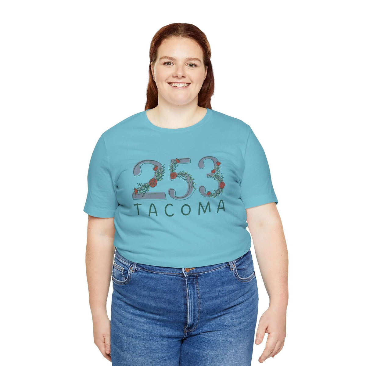 Woman wearing a teal 253 area code floral tee representing Pacific Northwest pride and style.