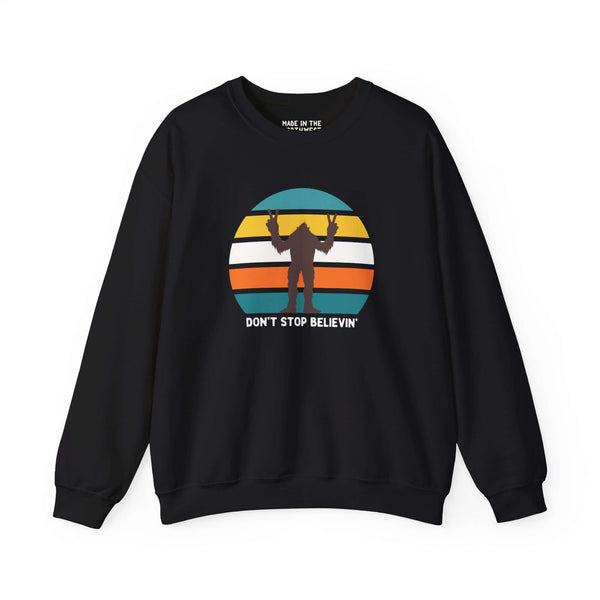 Don't Stop Believin' Bigfoot sweatshirt with colorful sasquatch graphic, perfect for folklore enthusiasts.