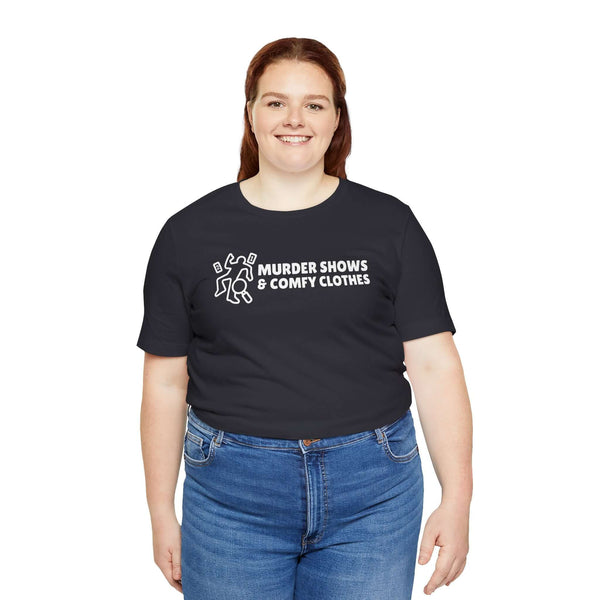 Woman wearing a black t-shirt with the text 'Murder Shows & Comfy Clothes' and a playful graphic design.