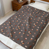 The Daily Grind Coffee Lovers Lightweight Cozy Blanket featuring playful coffee cup designs on a soft fabric.