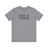 Gray premium soft tee featuring 'Made in Oregon' in rustic log font, perfect for outdoor enthusiasts.