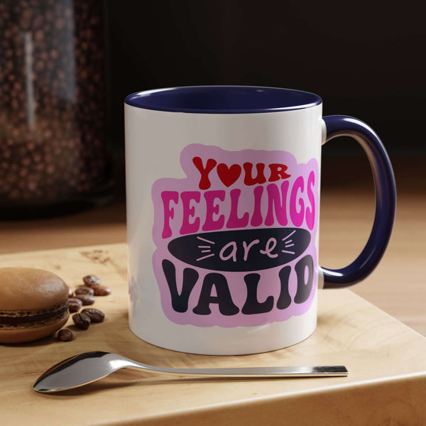 Your Feelings Are Valid Mug with colorful text design and navy handle, perfect for coffee or tea.