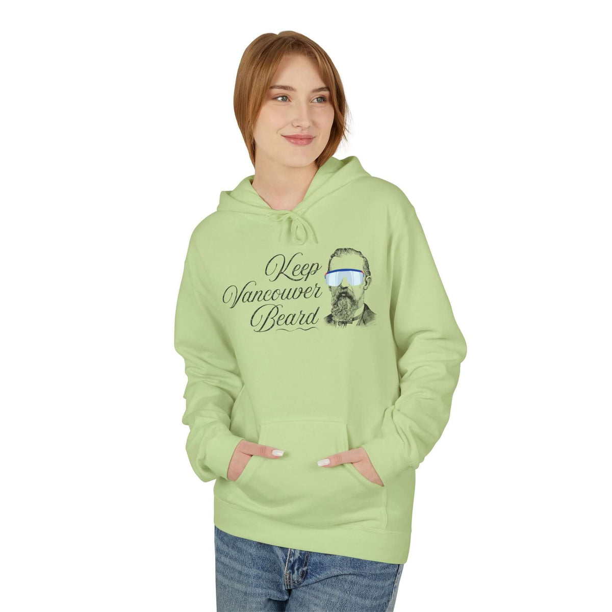 A woman wearing a light green Keep Vancouver Beard Hoodie with a bearded design, perfect for outdoor adventures.