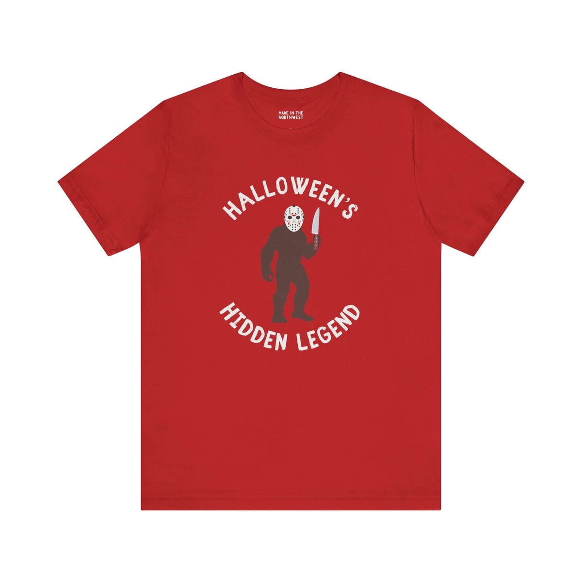 Halloween's Hidden Legend Bigfoot tee with creature holding knife on red shirt for spooky season.