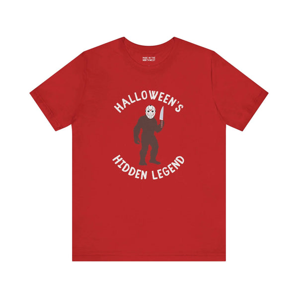 Halloween's Hidden Legend Bigfoot tee with creature holding knife on red shirt for spooky season.