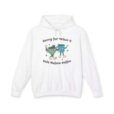 White hoodie with cartoon characters and text 'Sorry for What I Said Before Coffee' for coffee lovers.