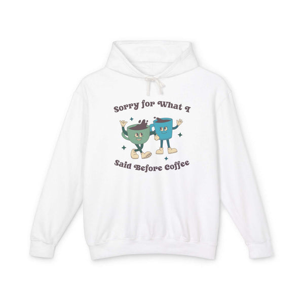 White hoodie with cartoon characters and text 'Sorry for What I Said Before Coffee' for coffee lovers.