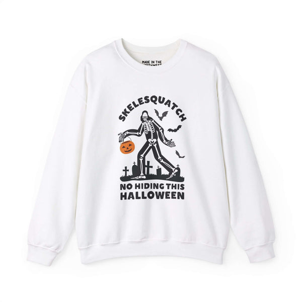 Skelesquatch Halloween sweatshirt featuring skeleton Sasquatch with trick-or-treat bucket in graveyard, perfect for spooky celebrations.