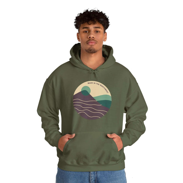 Man wearing Pacific Peaks Modern Circle Hoodie with mountain design, showcasing Northwest style in a muted colorway.