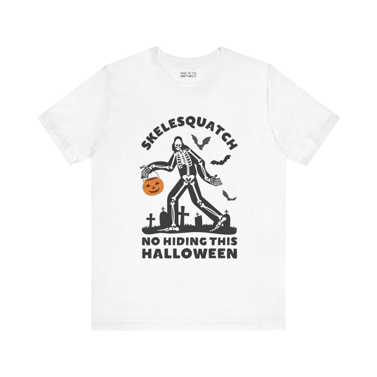 "Skelesquatch Halloween Tee featuring skeleton Sasquatch in a graveyard with pumpkin bucket and bats, perfect for spooky season"