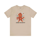I Brake for Bigfoot premium soft tee featuring a playful Sasquatch graphic in earthy tones.